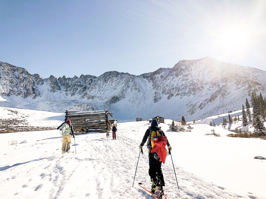 Backcountry skiers follow a popular skin track in Colorado's Rocky Mountains.